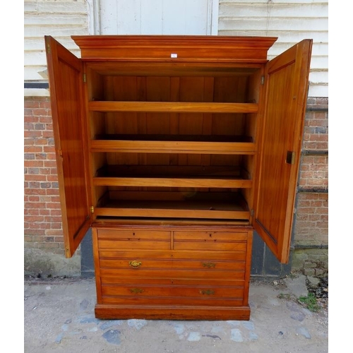 872 - An Edwardian satin walnut linen press with moulded cornice, the reeded and panelled doors opening on... 