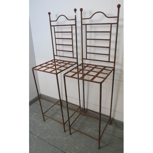 880 - A pair of vintage outdoor wrought iron stools with ball finials and iron strapwork seats, with footr... 