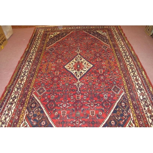 904 - A fine North West Persian Hamadan carpet, central diamond motif on cream ground, set on a deep red f... 