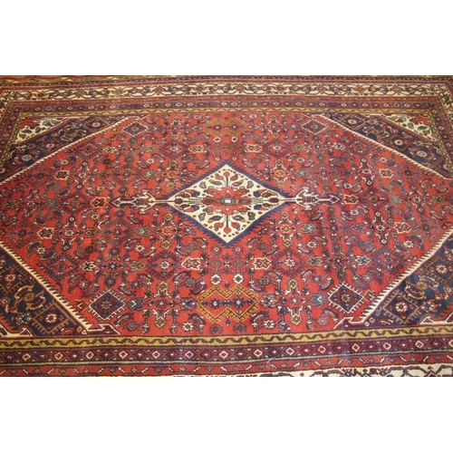 904 - A fine North West Persian Hamadan carpet, central diamond motif on cream ground, set on a deep red f... 