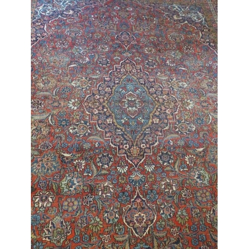 909 - A large good quality antique/vintage Persian Keshan carpet, decorated with central medallion and sty... 