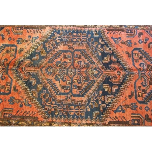 911 - A North West Persian Malayer rug, central blue motif on claret ground, with stylised birds. In good ... 