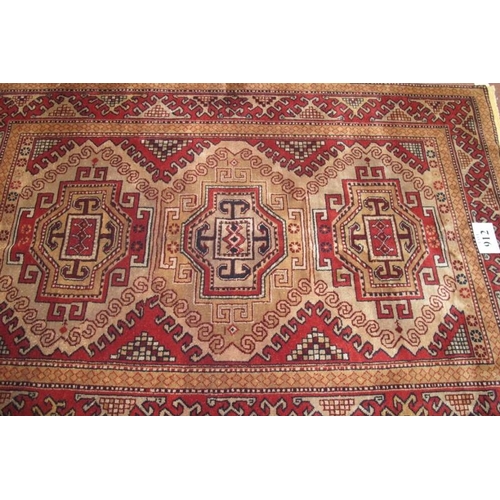 912 - A Turkish Kazak rug, a repeat tri pattern on soft muted ground, clean rug in condition 189 x 127cm.