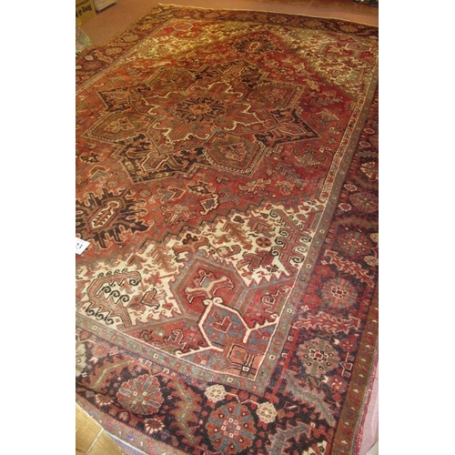 923 - A fine Persian (Iran) carpet, central pattern on claret ground, in very good condition 333 x 258cm.