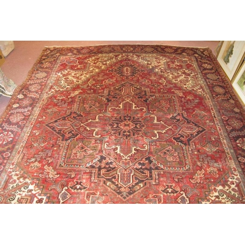 923 - A fine Persian (Iran) carpet, central pattern on claret ground, in very good condition 333 x 258cm.