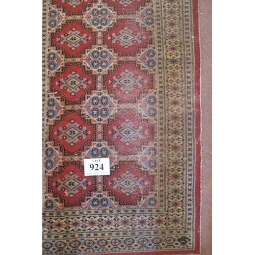 924 - A Persian runner, repeat central pattern on red ground, 545cm x 83cm, some wear/fading.