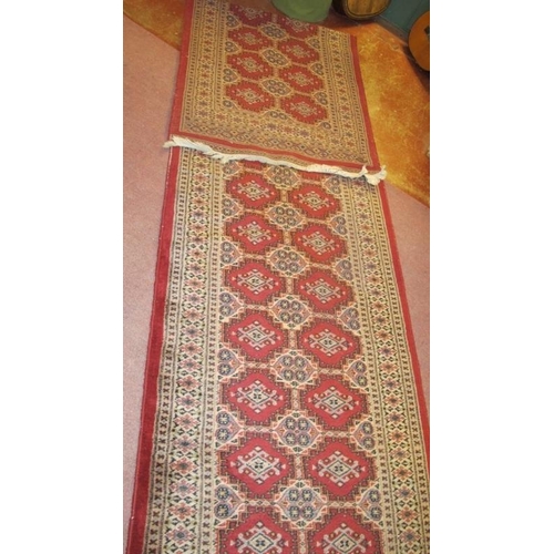 924 - A Persian runner, repeat central pattern on red ground, 545cm x 83cm, some wear/fading.