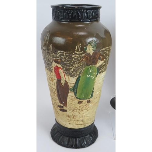 103 - Four Bretby pottery vases each hand decorated over relief traditional Dutch scenes. Tallest 32.5cm. ... 