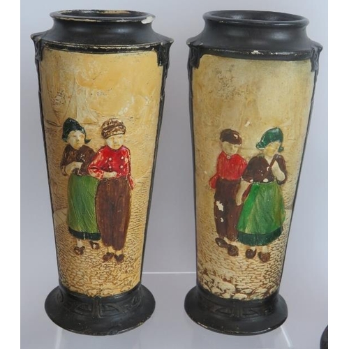 103 - Four Bretby pottery vases each hand decorated over relief traditional Dutch scenes. Tallest 32.5cm. ... 