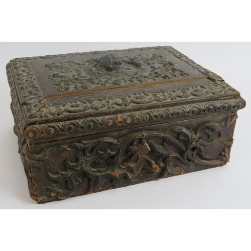 104 - A heavily embossed leather antique workbox with contents including pin cushions, scent bottle, greet... 