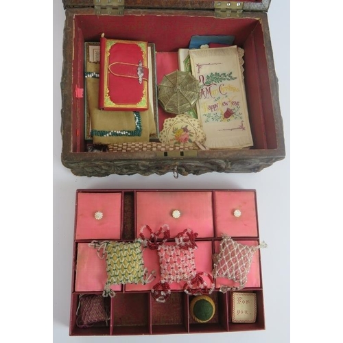 104 - A heavily embossed leather antique workbox with contents including pin cushions, scent bottle, greet... 