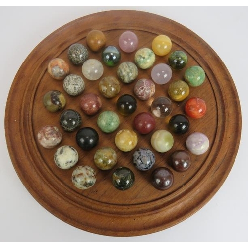 110 - A large turned wood solitaire board with full set of specimen stone marbles approx 28mm diameter. Bo... 