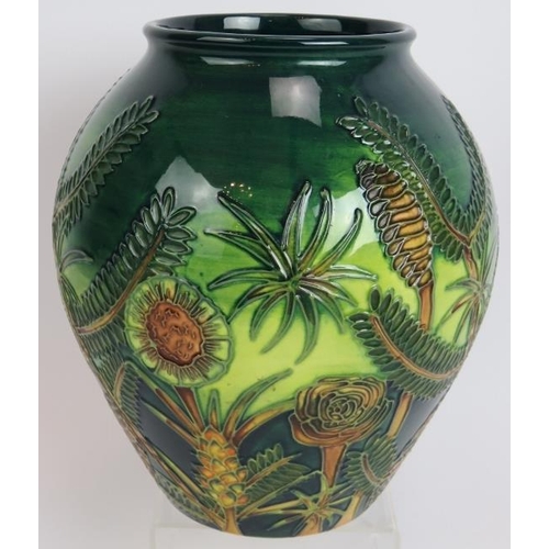 113 - A Moorcroft pottery vase c1997 decorated with tropical plants, signed to base. Height 22cm.
Conditio... 