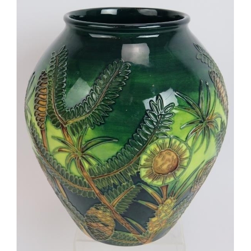 113 - A Moorcroft pottery vase c1997 decorated with tropical plants, signed to base. Height 22cm.
Conditio... 