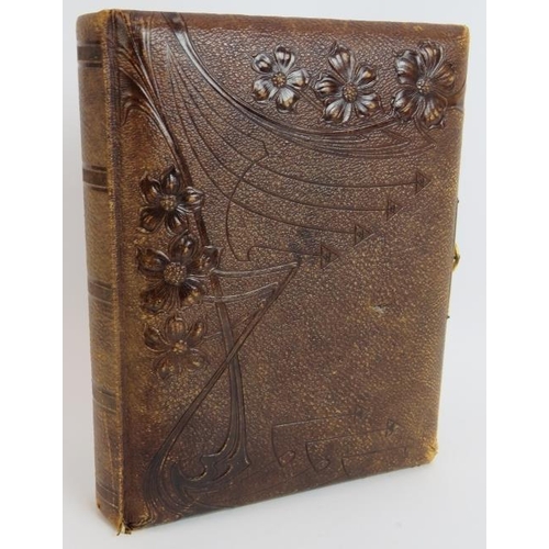 130 - A leather bound Victorian photo album with Art Nouveau decorated binding, gilt edges pages and gilt ... 