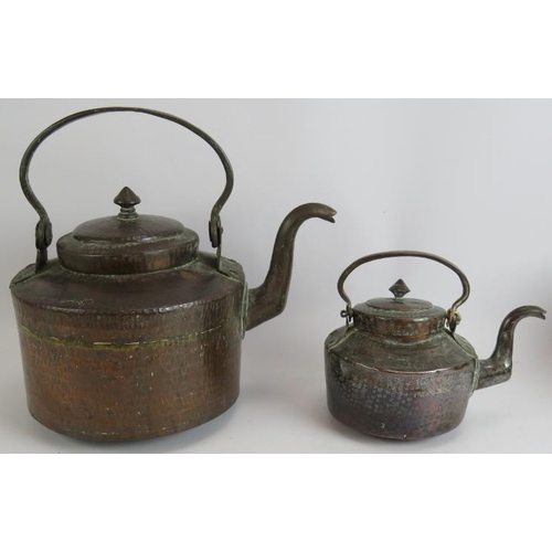 146 - Two beaten copper Omani kettles, largest 36cm tall and a similar beaten copper cooking pot, 32cm dia... 