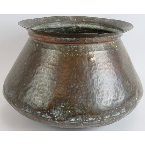 146 - Two beaten copper Omani kettles, largest 36cm tall and a similar beaten copper cooking pot, 32cm dia... 