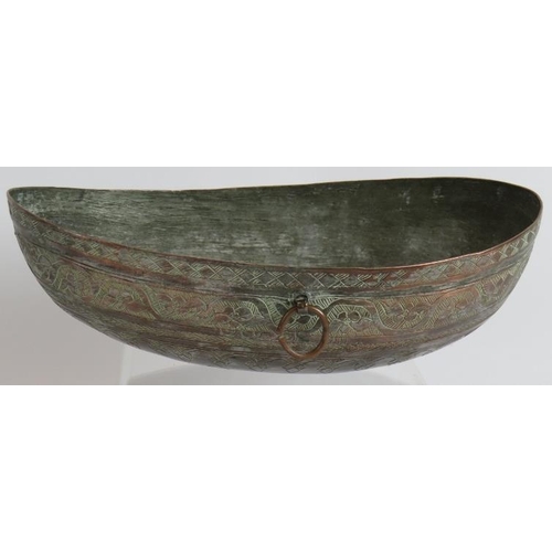 147 - A finely decorated Omani copper Kashkul begging bowl with intricately chased patterns and silvered i... 