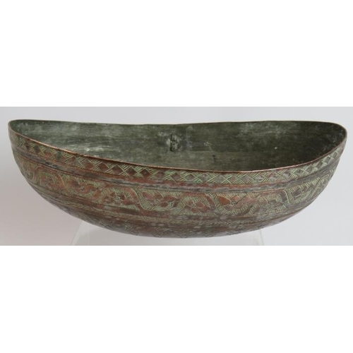 147 - A finely decorated Omani copper Kashkul begging bowl with intricately chased patterns and silvered i... 