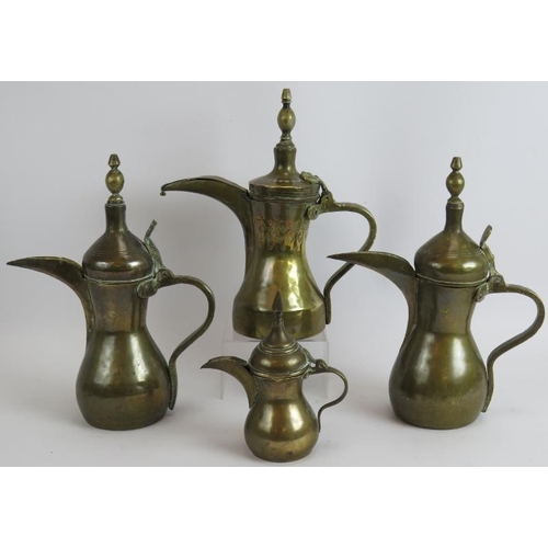 149 - Four middle Eastern brass Dallah coffee pots one with stamped decoration. Tallest 31cm.
Condition re... 