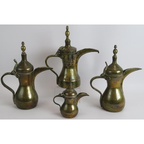 149 - Four middle Eastern brass Dallah coffee pots one with stamped decoration. Tallest 31cm.
Condition re... 