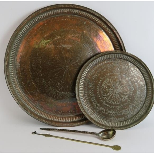 150 - Two large copper middle Eastern chargers, the largest signed to reverse, diameter 58cm, plus a coppe... 