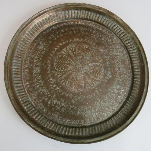 150 - Two large copper middle Eastern chargers, the largest signed to reverse, diameter 58cm, plus a coppe... 