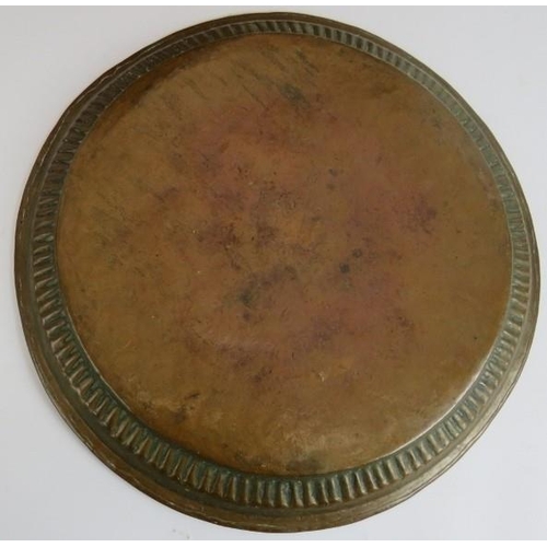 150 - Two large copper middle Eastern chargers, the largest signed to reverse, diameter 58cm, plus a coppe... 