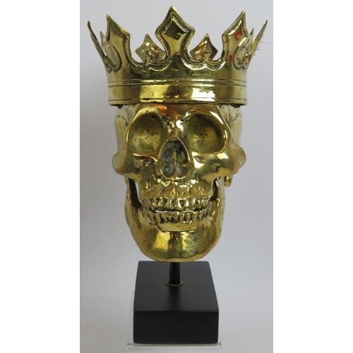 16 - A contemporary polished bronze model of a human skull wearing a crown mounted on a bespoke plinth. O... 