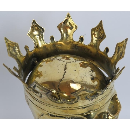 16 - A contemporary polished bronze model of a human skull wearing a crown mounted on a bespoke plinth. O... 