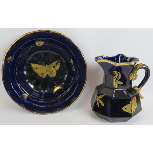 161 - An antique aesthetic movement blue jug and bowl set with gilt butterfly and insect decoration and an... 