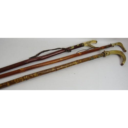 172 - Three hand crafted walking staffs, each with antler handles and decorated with Scottish metal plaque... 