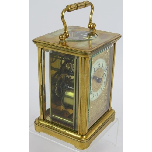 188 - A 19th century gilt brass cased carriage clock with engraved gilt mask and enamelled dial ting. Move... 