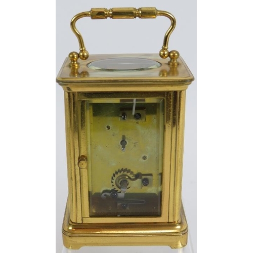 188 - A 19th century gilt brass cased carriage clock with engraved gilt mask and enamelled dial ting. Move... 