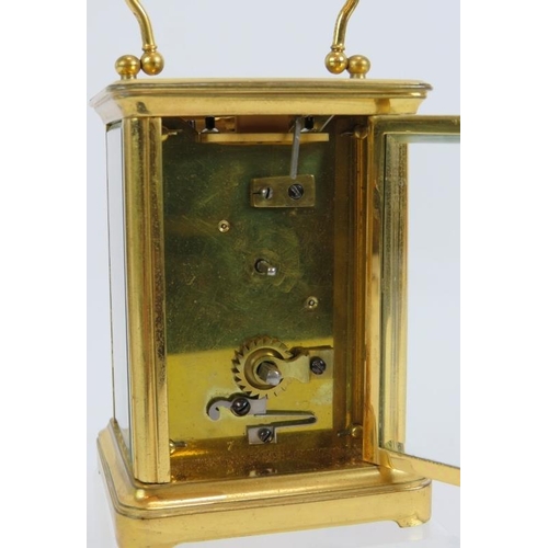 188 - A 19th century gilt brass cased carriage clock with engraved gilt mask and enamelled dial ting. Move... 