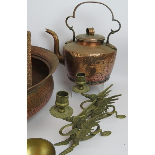 248 - Mixed copper and brassware including a large planished bowl, a heavy antique kettle, two mugs, dishe... 