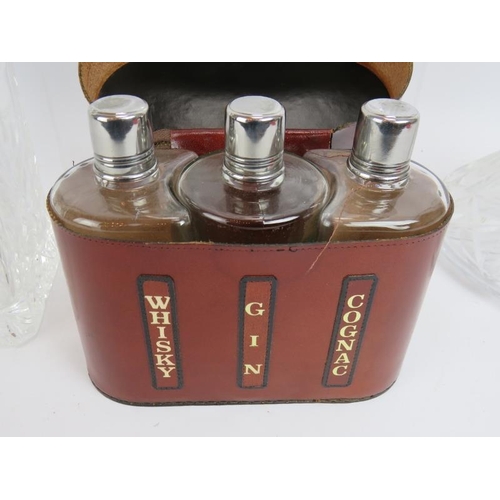 250 - Four cut crystal glass spirit decanters, a similar ships decanter and a vintage leather cased whisky... 