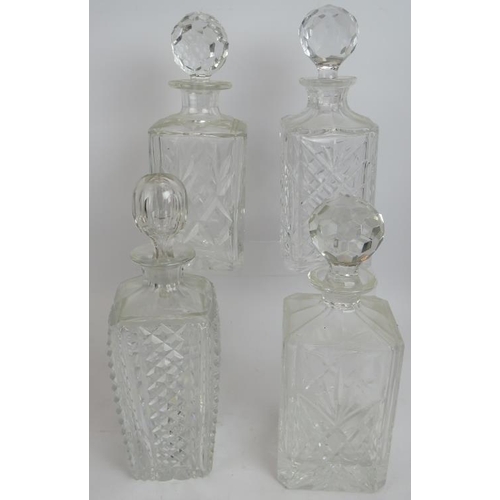 250 - Four cut crystal glass spirit decanters, a similar ships decanter and a vintage leather cased whisky... 