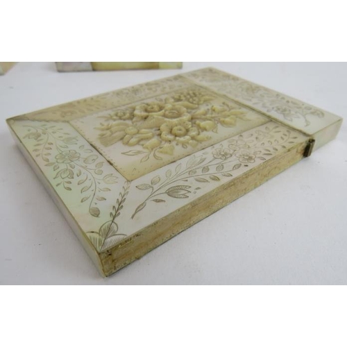 266 - Four 19th century mother of pearl card cases, one with carved decoration, one with white metal carto... 