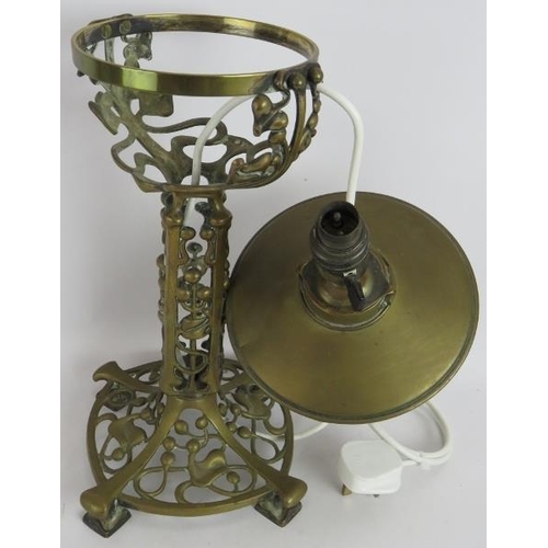 28 - An Art Nouveau cast brass oil lamp with ivy and berry patterned base later converted to electricity.... 