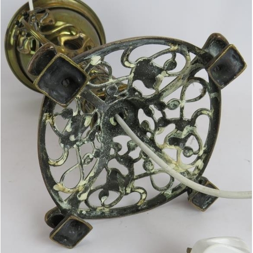 28 - An Art Nouveau cast brass oil lamp with ivy and berry patterned base later converted to electricity.... 