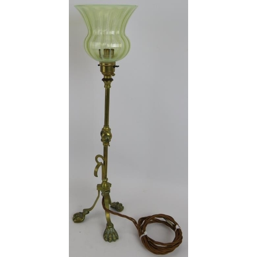 285 - A brass Arts & Crafts desk lamp with adjustable arm, standing on lion paw feet and with a green Vase... 