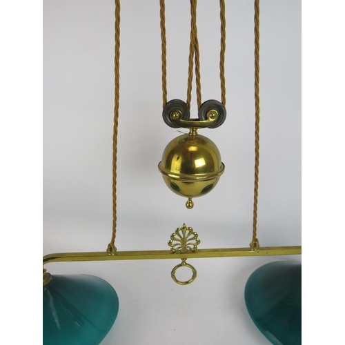 287 - A period brass two lamp rise and fall ceiling light with Emeralite green glass shades. Width 78cm.
C... 