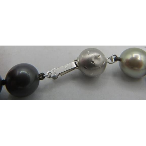 408 - An AAAA quality 'peacock' Tahitian Southsea pearl necklace with radiant lustre and set with 8 diamon... 