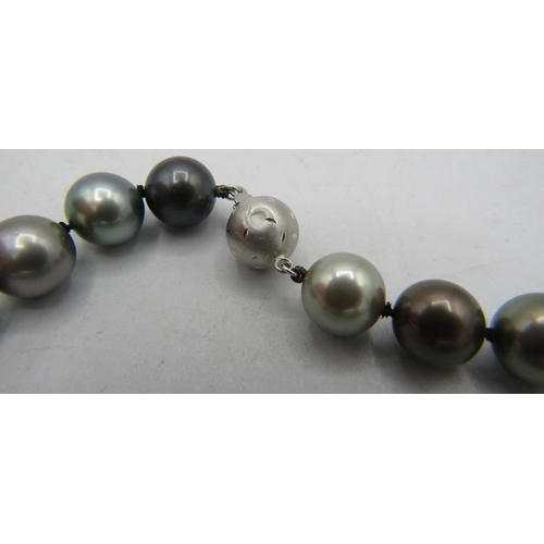 408 - An AAAA quality 'peacock' Tahitian Southsea pearl necklace with radiant lustre and set with 8 diamon... 