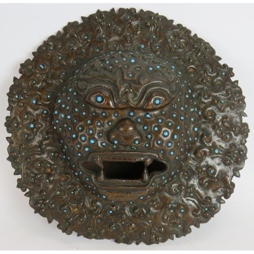 45 - An antique bronze Indian temple mask inset with small blue stones. Believed to be used for warding o... 