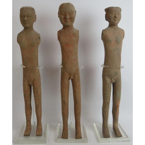 52 - A series of three early Chinese pottery male figures, probably tomb attendants, in the Han/Tang styl... 