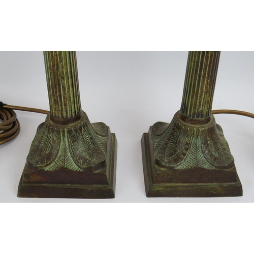 64 - A pair of cast bronze classical column lamps with acanthus leaf bases and capitals and a Verdigris f... 