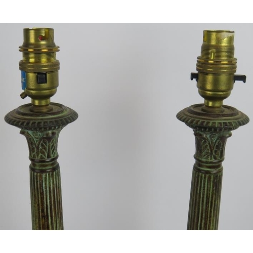 64 - A pair of cast bronze classical column lamps with acanthus leaf bases and capitals and a Verdigris f... 