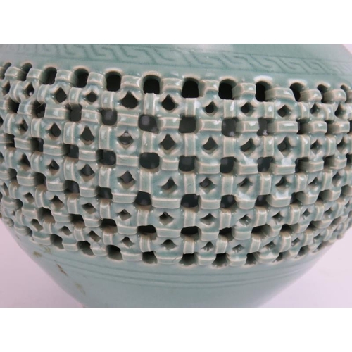 66 - A Chinese celadon glaze porcelain baluster vase of double wall construction with reticulated outer a... 